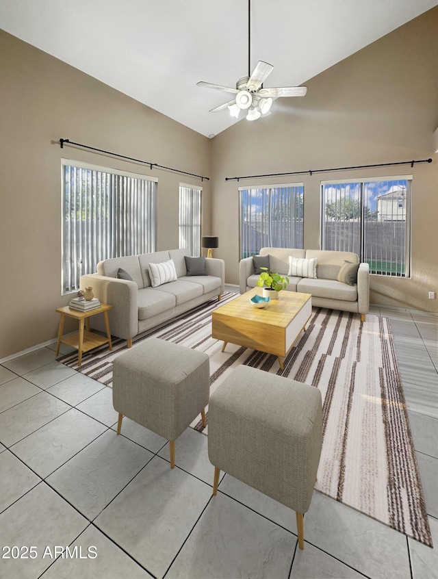 living room with plenty of natural light, light tile patterned floors, and ceiling fan