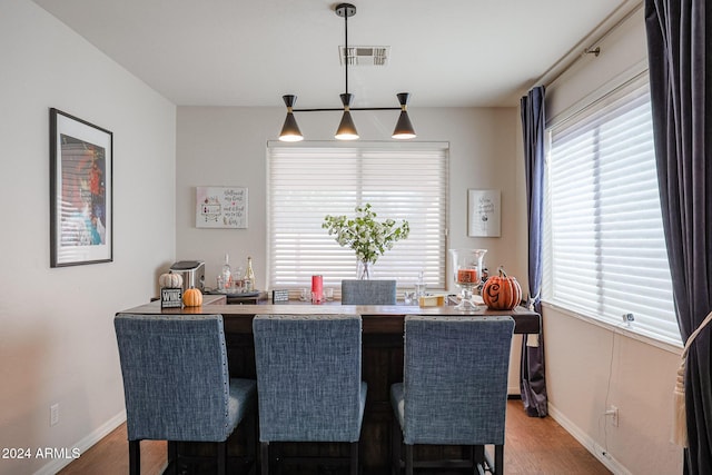 14586 W Columbus Ave, Goodyear, AZ 85395 - dining area featuring wood finished floors, baseboards, and a dry bar