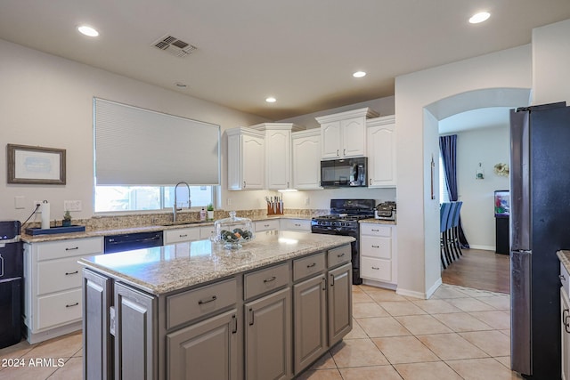 14586 W Columbus Ave, Goodyear, AZ 85395 - kitchen featuring black appliances, a sink, gray cabinetry, white cabinets, and arched walkways