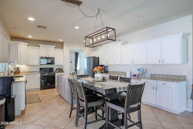 14586 W Columbus Ave, Goodyear, AZ 85395 - kitchen with black appliances, a sink, light tile patterned floors, white cabinetry, and recessed lighting