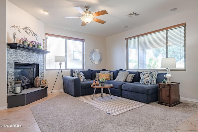 14586 W Columbus Ave, Goodyear, AZ 85395 - living room with light tile patterned floors, a ceiling fan, baseboards, and a stone fireplace