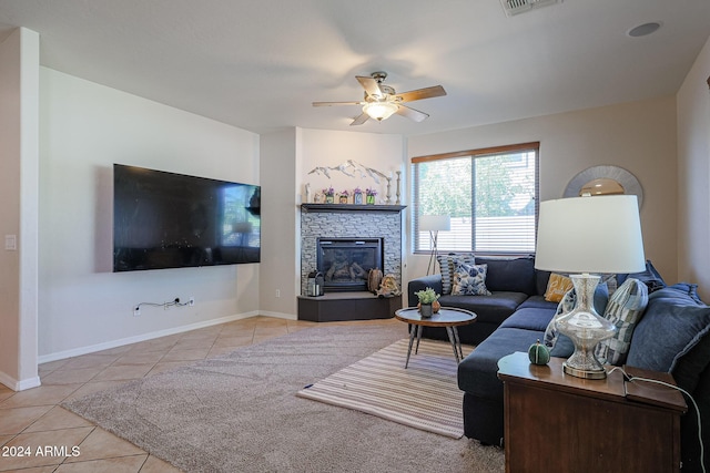 14586 W Columbus Ave, Goodyear, AZ 85395 - tiled living room featuring a ceiling fan, a tiled fireplace, and baseboards