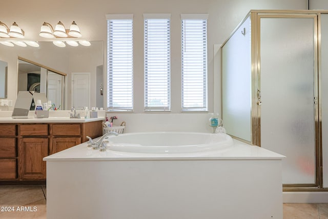 14586 W Columbus Ave, Goodyear, AZ 85395 - full bathroom with tile patterned floors, a garden tub, a stall shower, and vanity