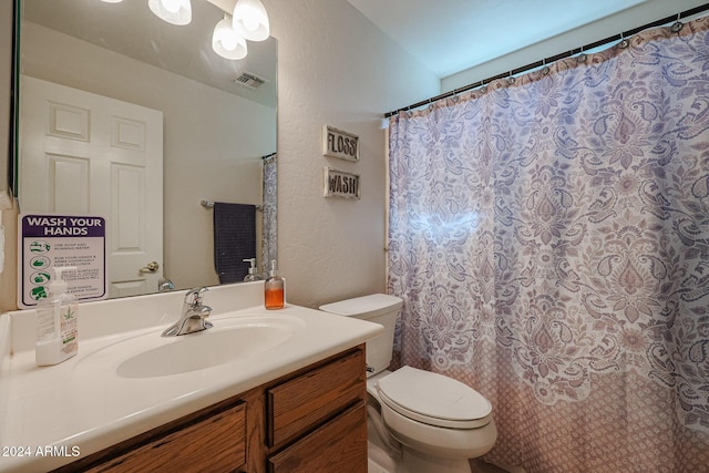 14586 W Columbus Ave, Goodyear, AZ 85395 - bathroom with toilet, vanity, and a textured wall