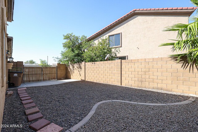 14586 W Columbus Ave, Goodyear, AZ 85395 - fenced backyard featuring a patio area