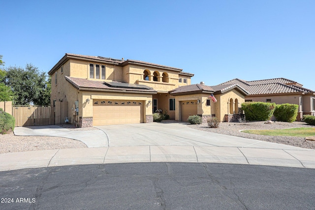 14586 W Columbus Ave, Goodyear, AZ 85395 - mediterranean / spanish house with stucco siding, solar panels, concrete driveway, fence, and a garage