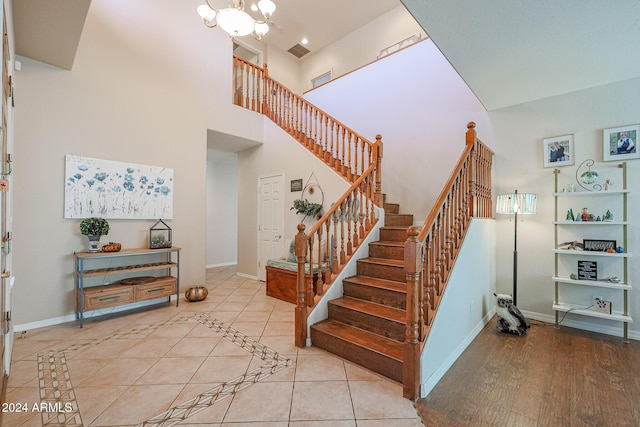 14586 W Columbus Ave, Goodyear, AZ 85395 - staircase with a high ceiling, a chandelier, baseboards, and tile patterned floors