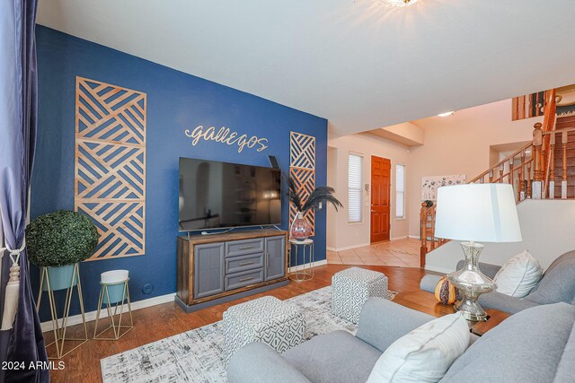 14586 W Columbus Ave, Goodyear, AZ 85395 - living room featuring stairway, baseboards, and wood finished floors