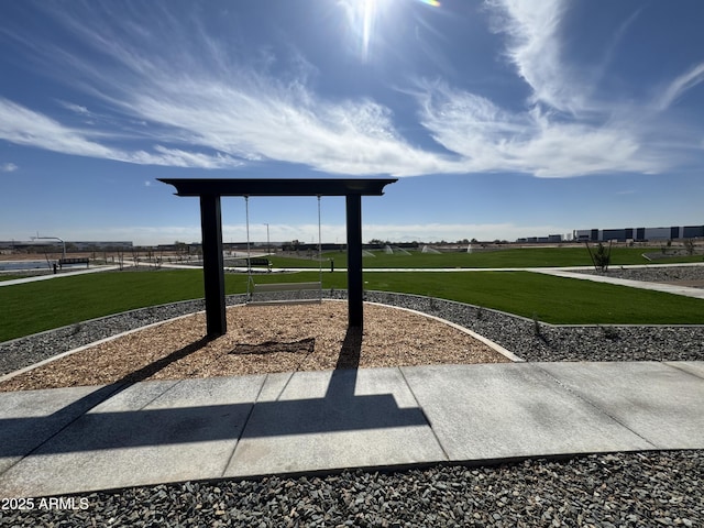 view of community featuring playground community and a lawn