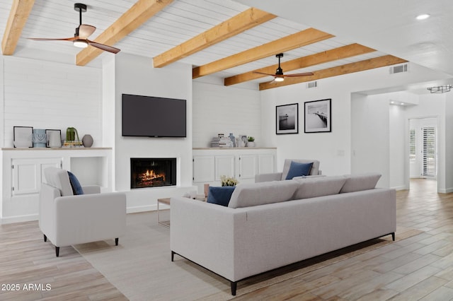 5756 N 78th Pl, Scottsdale, AZ 85250 - living area featuring ceiling fan, beam ceiling, a warm lit fireplace, light wood-style floors, and baseboards