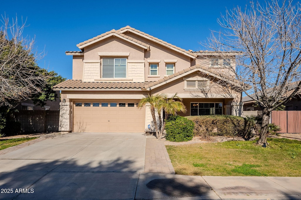 view of front of home with a garage and a front lawn