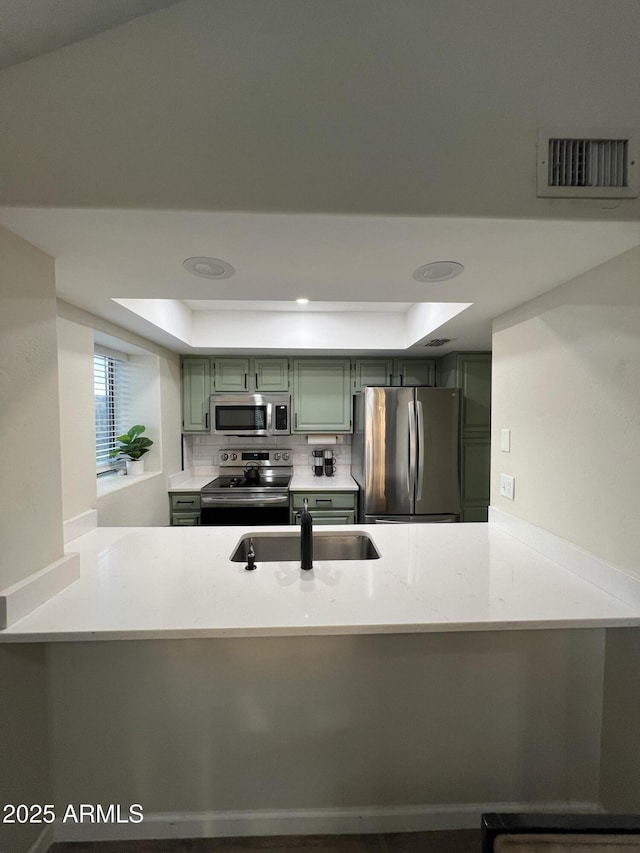 4040 N Weimer Pl Unit 4, Tucson, AZ 85719 - kitchen with a peninsula, a raised ceiling, visible vents, and appliances with stainless steel finishes
