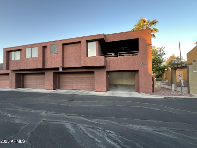 4040 N Weimer Pl Unit 4, Tucson, AZ 85719 - townhome / multi-family property with an attached garage, stucco siding, and a balcony