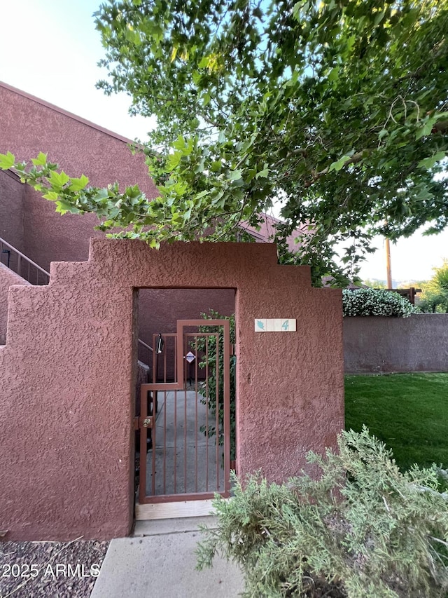 4040 N Weimer Pl Unit 4, Tucson, AZ 85719 - doorway to property featuring a gate, fence, and stucco siding
