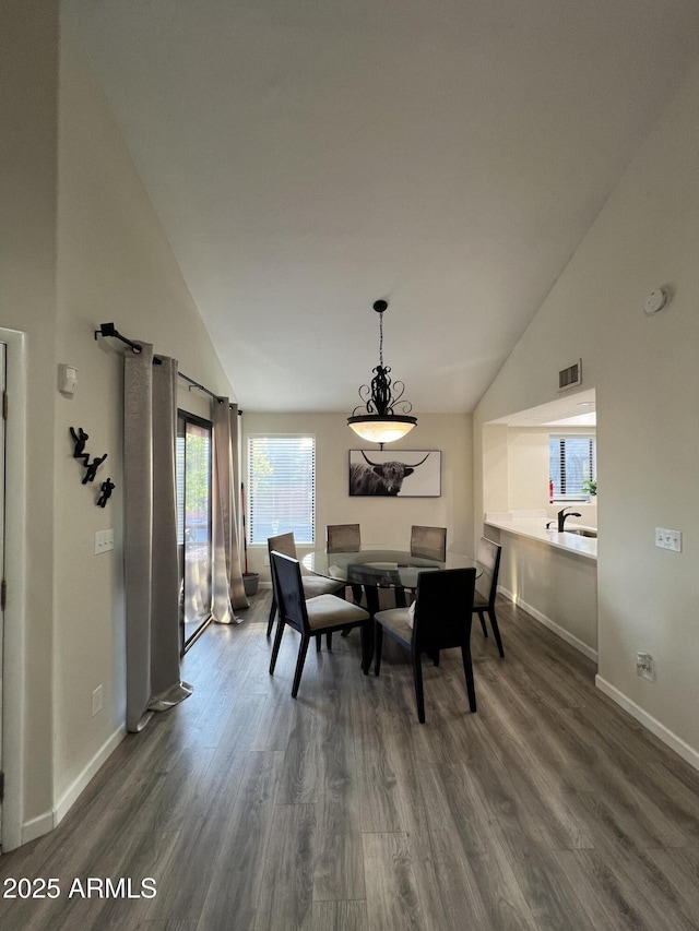 4040 N Weimer Pl Unit 4, Tucson, AZ 85719 - dining space featuring high vaulted ceiling, visible vents, baseboards, and dark wood-style floors