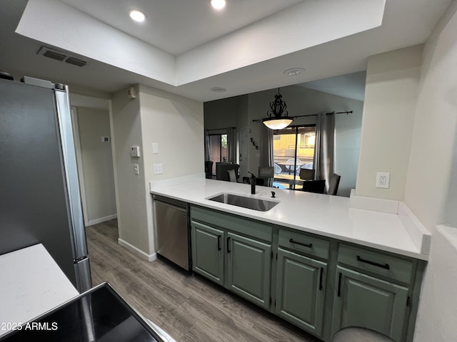 4040 N Weimer Pl Unit 4, Tucson, AZ 85719 - kitchen with wood finished floors, a sink, visible vents, light countertops, and appliances with stainless steel finishes