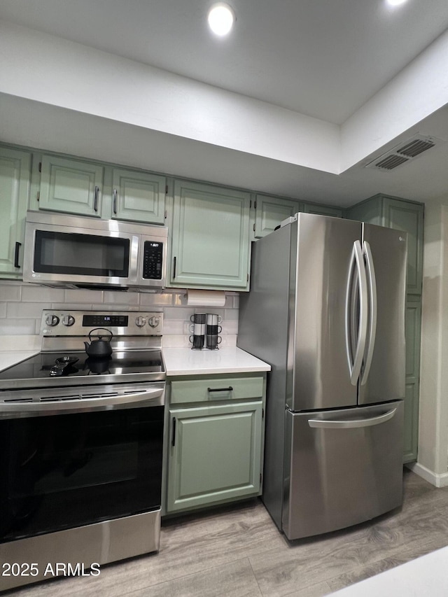 4040 N Weimer Pl Unit 4, Tucson, AZ 85719 - kitchen featuring light countertops, green cabinetry, stainless steel appliances, and visible vents