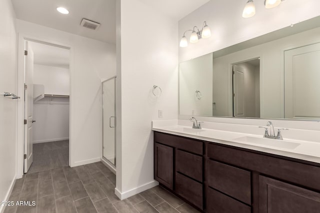 12369 W Marguerite Ave, Avondale, AZ 85323 - bathroom with a sink, visible vents, and a shower stall