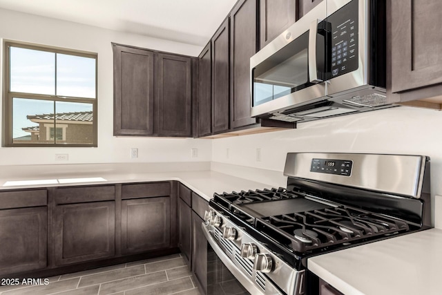12369 W Marguerite Ave, Avondale, AZ 85323 - kitchen with stainless steel appliances, dark brown cabinetry, and light countertops