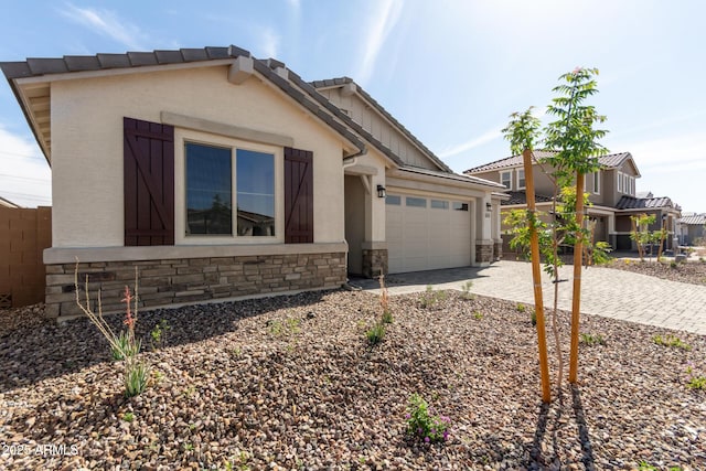12369 W Marguerite Ave, Avondale, AZ 85323 - ranch-style home with a garage, stucco siding, fence, stone siding, and driveway