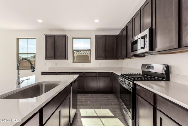 12369 W Marguerite Ave, Avondale, AZ 85323 - kitchen featuring dark brown cabinetry, a sink, a wealth of natural light, and stainless steel appliances