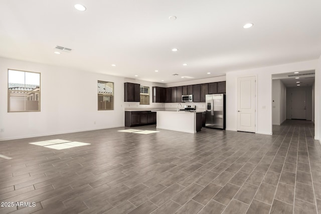 12369 W Marguerite Ave, Avondale, AZ 85323 - unfurnished living room with recessed lighting, visible vents, baseboards, and wood finished floors
