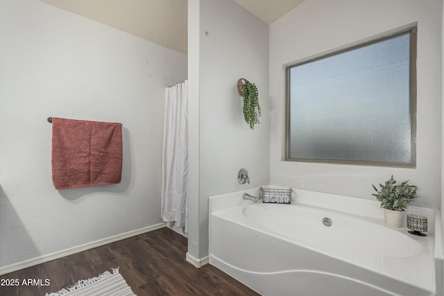 12376 W Hazelwood St, Avondale, AZ 85392 - bathroom featuring a bath, baseboards, and wood finished floors