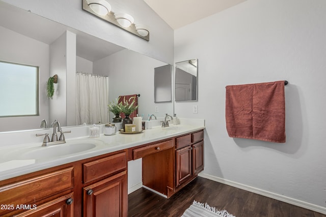 12376 W Hazelwood St, Avondale, AZ 85392 - full bath with double vanity, baseboards, a sink, and wood finished floors