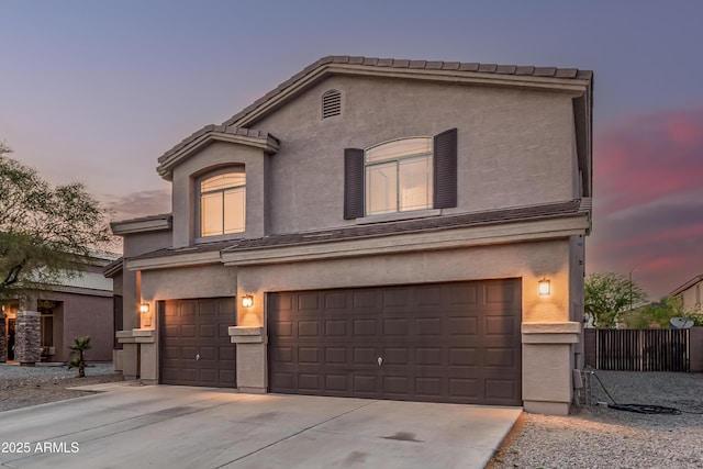 12376 W Hazelwood St, Avondale, AZ 85392 - traditional-style home featuring concrete driveway, stucco siding, a tiled roof, and an attached garage