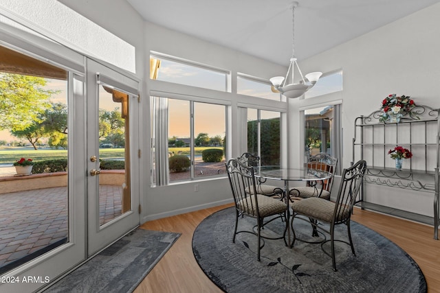 sunroom / solarium featuring an inviting chandelier