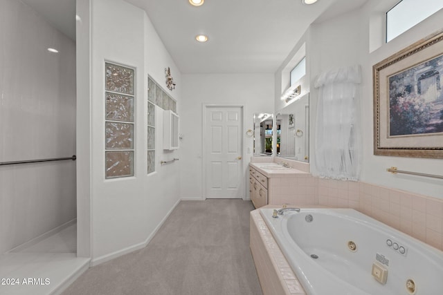 bathroom with vanity and tiled bath