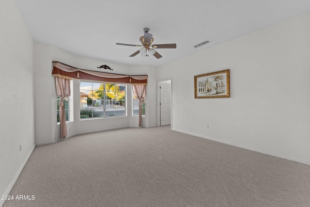 carpeted spare room with ceiling fan