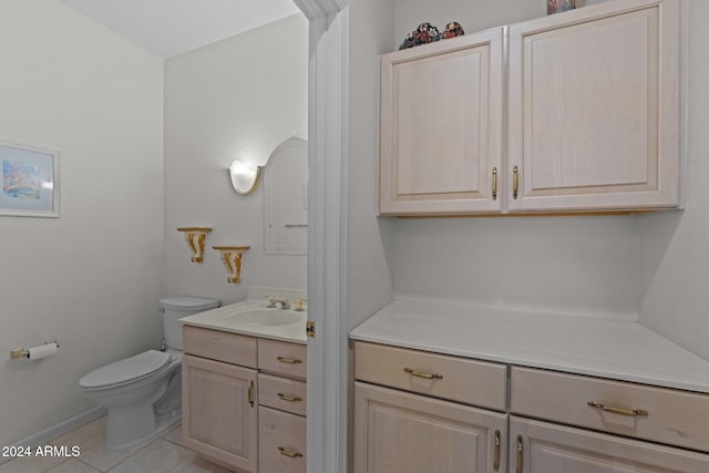 bathroom featuring tile patterned floors, vanity, and toilet