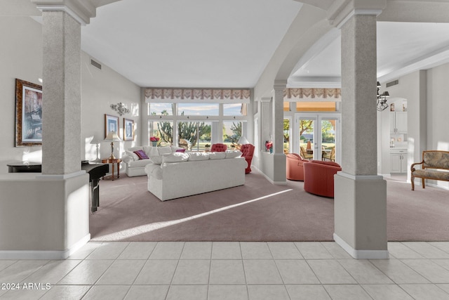 living room featuring french doors, light colored carpet, and ornate columns