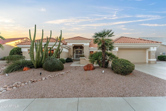 mediterranean / spanish-style home with a garage