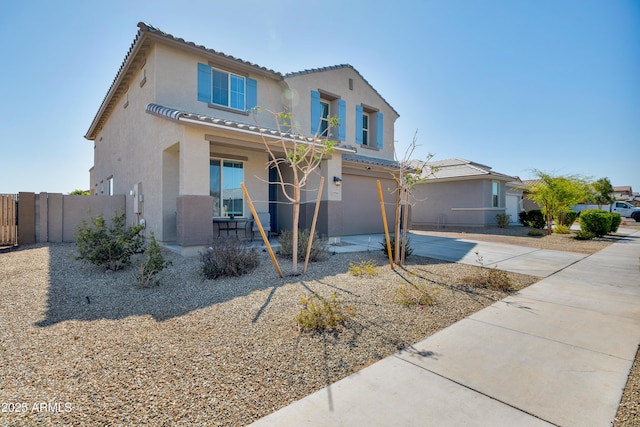 view of front facade featuring fence, stucco siding, concrete driveway, a garage, and a tiled roof