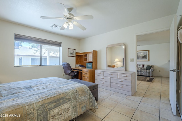 bedroom featuring light tile patterned flooring, ceiling fan, and a desk