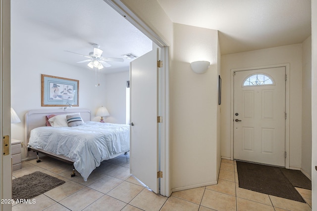 entrance foyer featuring light tile patterned flooring and ceiling fan
