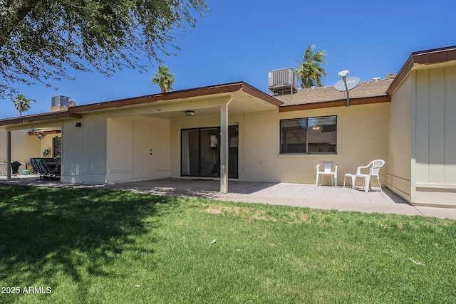 back of house with a patio, a yard, and central AC