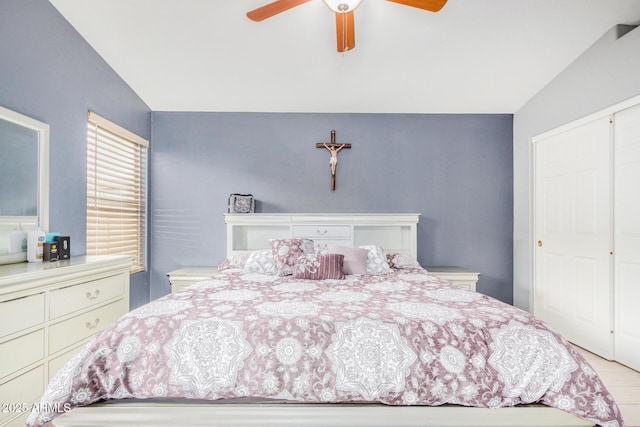 bedroom featuring ceiling fan, lofted ceiling, and a closet