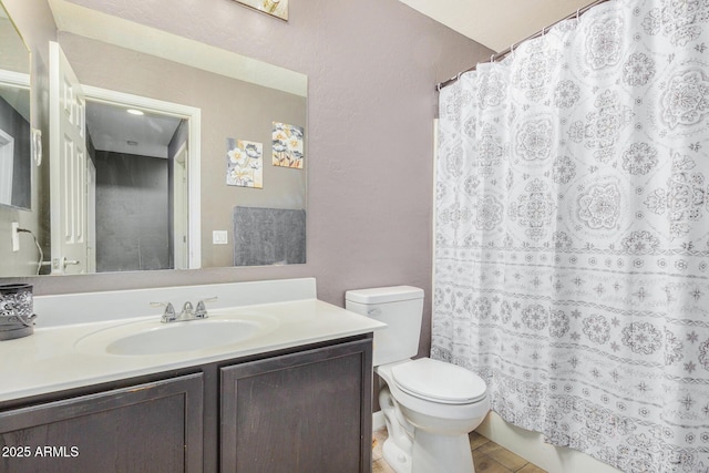 bathroom featuring toilet and vanity