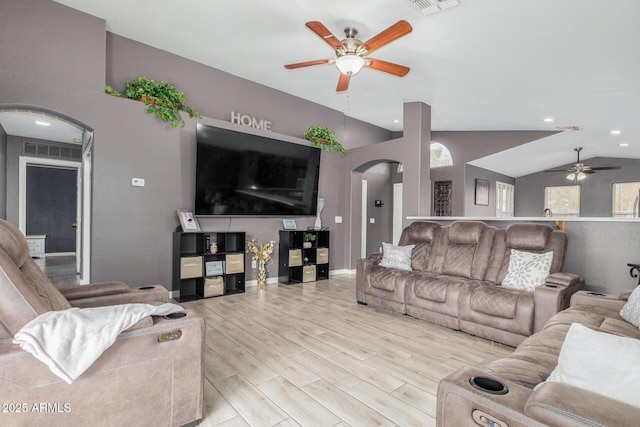 living room with ceiling fan, lofted ceiling, and light hardwood / wood-style flooring