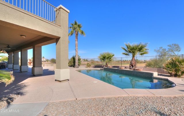 view of pool with a patio area and ceiling fan