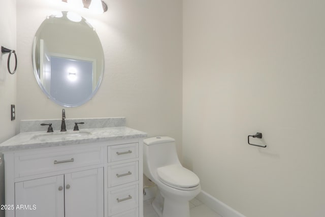 bathroom featuring tile patterned floors, vanity, and toilet