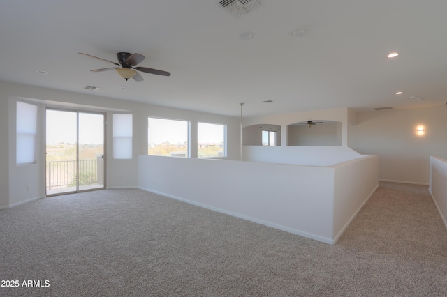 carpeted empty room featuring ceiling fan