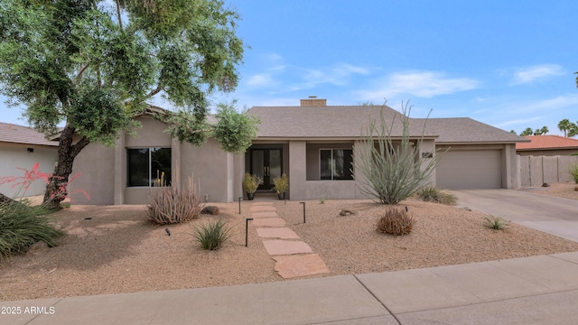 7806 E Via De La Entrada, Scottsdale, AZ 85258 - ranch-style home featuring driveway, stucco siding, a garage, and a chimney