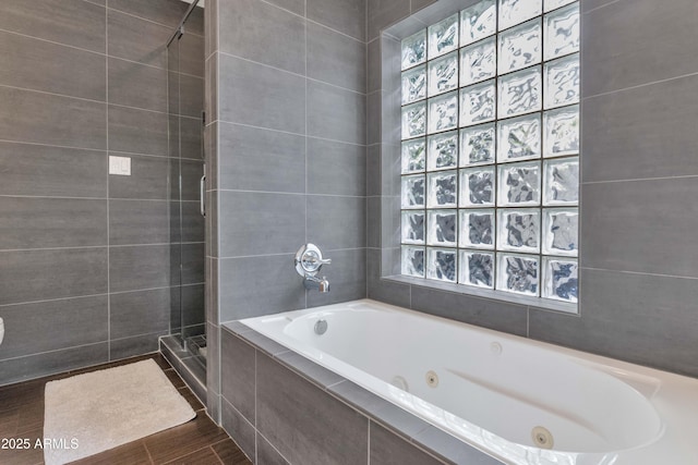 7806 E Via De La Entrada, Scottsdale, AZ 85258 - full bathroom with a jetted tub, a tile shower, and wood finished floors