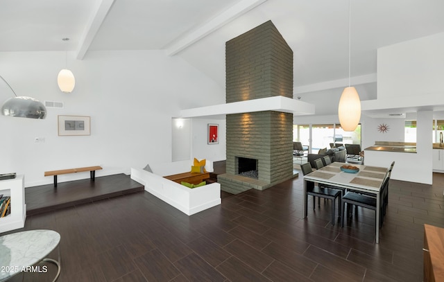 7806 E Via De La Entrada, Scottsdale, AZ 85258 - living room featuring beam ceiling, a brick fireplace, wood finished floors, and high vaulted ceiling
