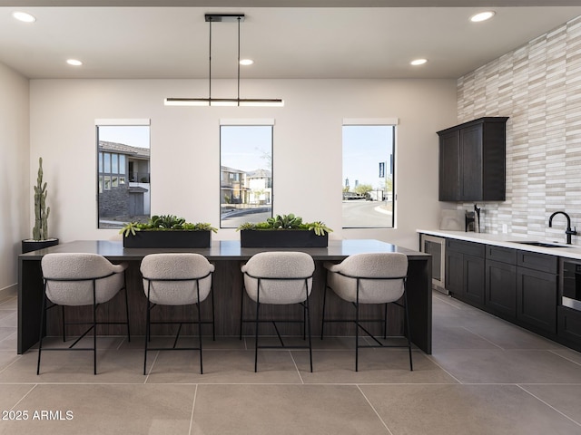 2121 W Sonoran Desert Dr Unit 43, Phoenix, AZ 85085 - kitchen with plenty of natural light, a sink, a breakfast bar, recessed lighting, and backsplash
