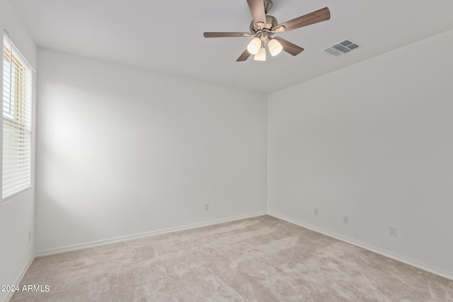 empty room featuring carpet floors and ceiling fan